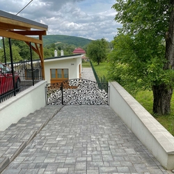A luxurious hand-forged gate with oak branches – fencing of a family house in a village in Slovakia A luxurious hand-forged gate with oak branches – fencing of a family house in a village in Slovakia