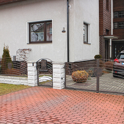 A modern design with a logo on a gate - A wrought iron gate and fence