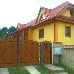 A wrought iron gate - wood - metal, harmony of materials