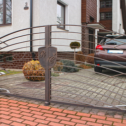 A modern design with a logo on a gate - A modern gate